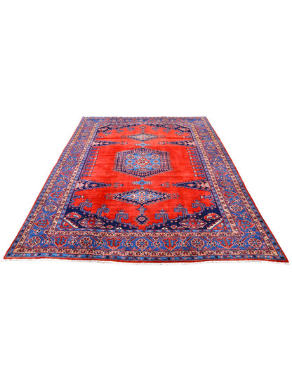 Tappeto Heriz persiano 339x219 cm, annodato a mano su telaio tradizionale, lana e cotone con colori vegetali, fondo rosso e dettagli blu.