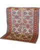 Tappeto Shirvan 165x122 cm con motivi geometrici e floreali in rosso, blu, verde e crema su fondo beige.