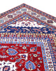 Tappeto Shirvan 274x184 cm con fondo rosso, medaglione centrale blu e avorio e bordure geometriche multicolori, tramato ed annodato a mano.