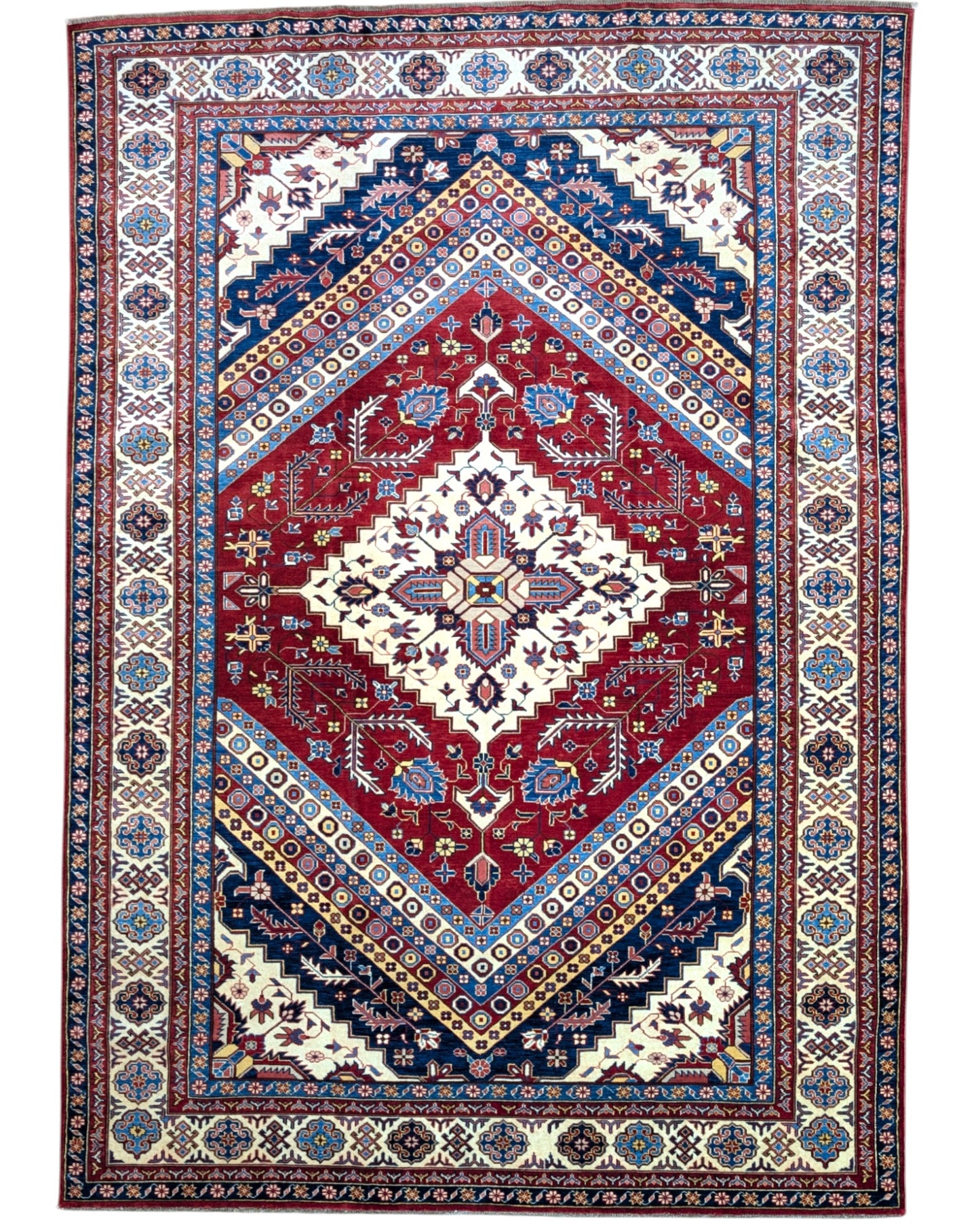 Tappeto Shirvan 274x184 cm con fondo rosso, medaglione centrale blu e avorio e bordure geometriche multicolori, tramato ed annodato a mano.