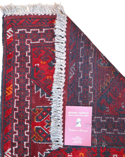 Tappeto Turkman 267x76 cm, corridore persiano in lana annodata a mano, fondo bordeaux con motivi geometrici rossi e arancio.