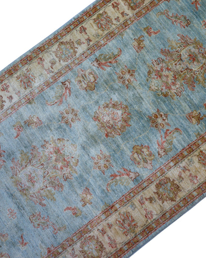Tappeto Ziegler 257x77 cm, provenienza Afghanistan, fondo azzurro con motivi floreali beige e rosso mattone, corridore annodato a mano in lana vegetale.
