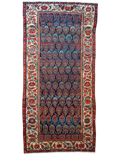 Tappeto Malayer antico 350x176 cm con fondo blu scuro, motivi geometrici rossi e avorio e bordura floreale vivace, tramato ed annodato a mano, provenienza Persia.