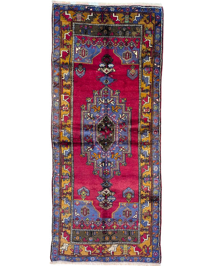 Tappeto Caucaso Antico 230x97 cm annodato a mano con medaglione geometrico e bordura tradizionale.
