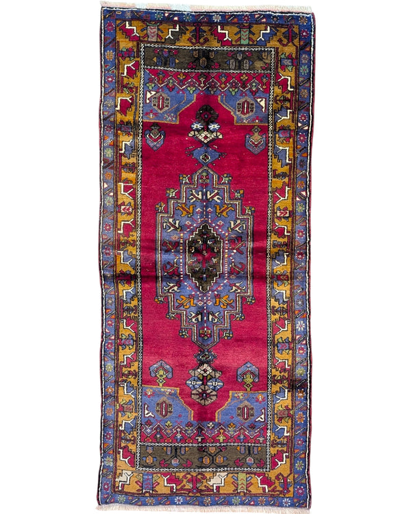 Tappeto Caucaso Antico 230x97 cm annodato a mano con medaglione geometrico e bordura tradizionale.