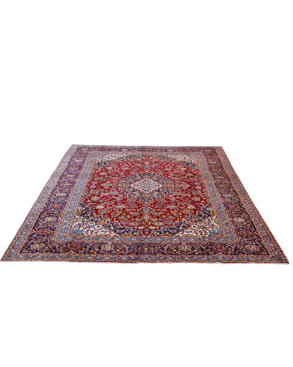 Tappeto persiano Kashan 400x300 cm, fondo rosso con medaglione centrale e cornice floreale, annodato a mano in lana vegetale.