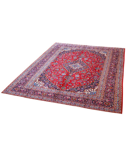 Tappeto persiano Kashan 402x297 cm, fondo rosso con medaglione centrale blu e avorio, annodato a mano in lana vegetale.