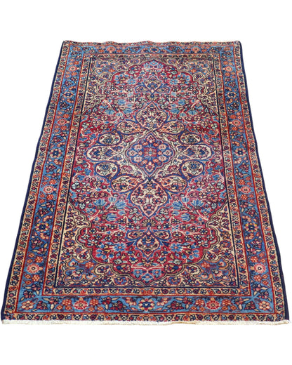 Tappeto Liliyan 180x50 cm annodato a mano con medaglione floreale e bordure blu decorate.
