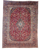 Tappeto persiano Mashhad 385x290 cm, fondo rosso con medaglione centrale e cornice floreale blu e beige, annodato a mano in lana vegetale.