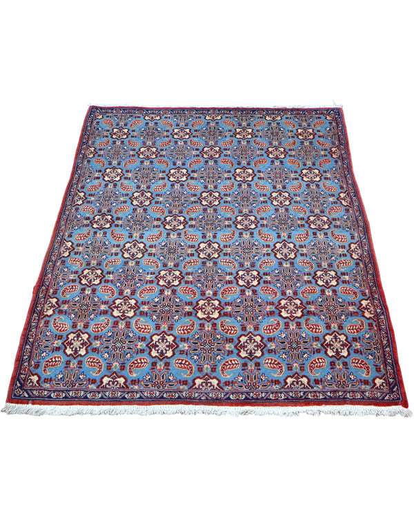 Tappeto Najafabad azzurro 151x107 cm con disegni floreali in salotto