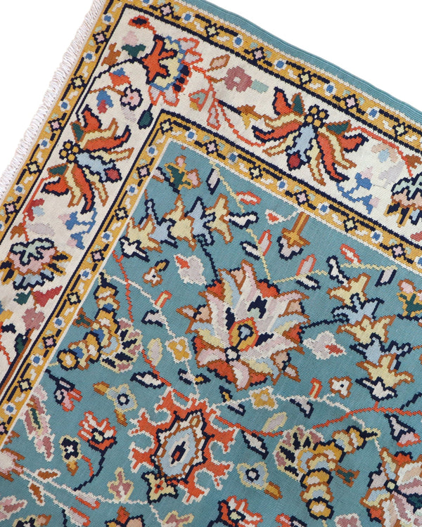 Tappeto Kilim Turco 290x200 cm con fondo azzurro, motivi floreali e geometrici multicolori, tramato ed annodato a mano.