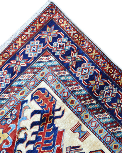 Tappeto Shirvan Afghan 157x121 cm con fondo avorio, motivi geometrici blu e rossi, tramato ed annodato a mano, provenienza Afghanistan.