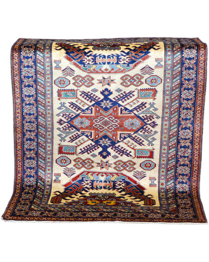 Tappeto Shirvan Afghan 157x121 cm con fondo avorio, motivi geometrici blu e rossi, tramato ed annodato a mano, provenienza Afghanistan.