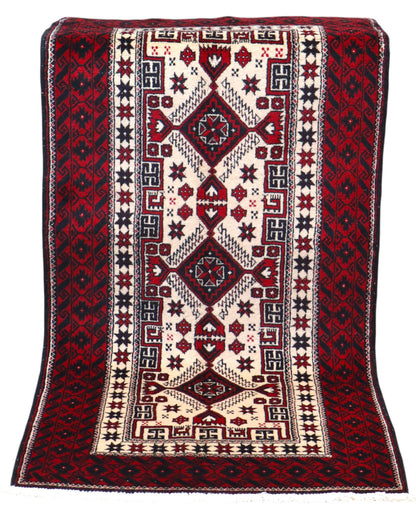 Tappeto Balochistan 187x95 cm annodato a mano, fondo avorio con motivi geometrici rossi, neri e verdi.