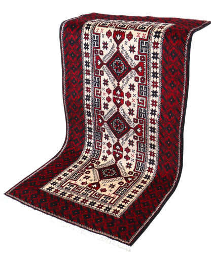 Tappeto Balochistan 187x95 cm annodato a mano, fondo avorio con motivi geometrici rossi, neri e verdi.