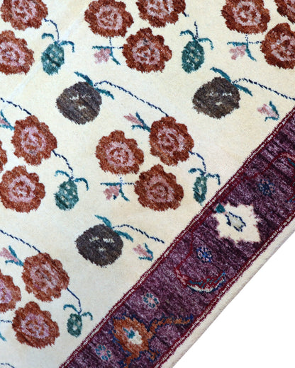 Tappeto Ziegler annodato a mano 180x126 cm con motivi floreali su fondo avorio e bordura viola.