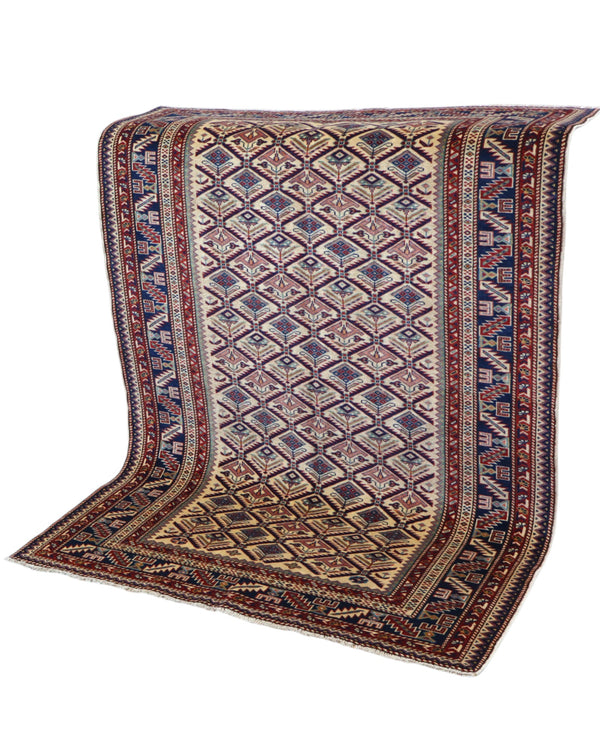 Tappeto Shirvan 167x122 cm in lana annodata a mano, fondo chiaro con rombi geometrici e cornice caucasica.