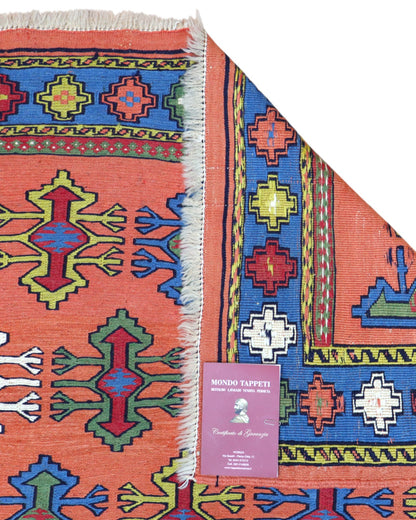 Tappeto Kilim Persia 166x120 cm tessuto a mano, con motivi geometrici multicolore su fondo arancio e bordo blu.