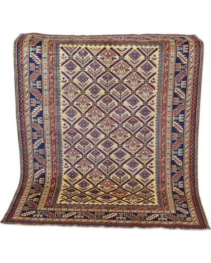 Tappeto Shirvan 166x120 cm in lana annodata a mano, fondo chiaro con rombi geometrici e cornici caucasiche.