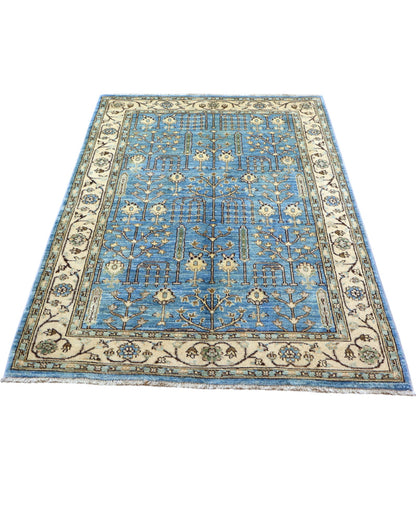 Tappeto Ziegler 188x123 cm con disegno floreale su fondo azzurro e bordura beige, perfetto per arredamenti eleganti e moderni.