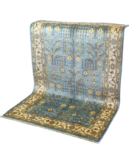 Tappeto Ziegler 188x123 cm con disegno floreale su fondo azzurro e bordura beige, perfetto per arredamenti eleganti e moderni.