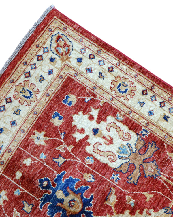 Tappeto Ziegler 170x120 cm con fondo rosso bordeaux e motivi floreali avorio e blu, tramato ed annodato a mano, provenienza Afghanistan.