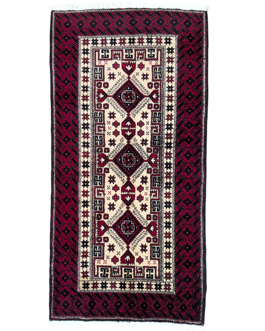 Tappeto Balochistan 187x95 cm annodato a mano, fondo avorio con motivi geometrici rossi, neri e verdi.