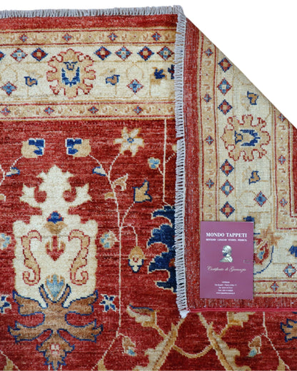 Tappeto Ziegler 170x120 cm con fondo rosso bordeaux e motivi floreali avorio e blu, tramato ed annodato a mano, provenienza Afghanistan.