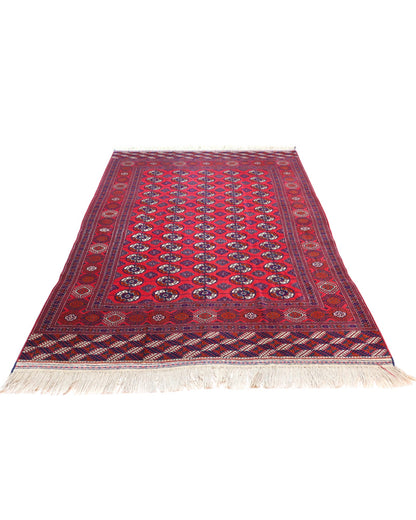 Tappeto Bukhara 278x180 cm con fondo rosso e motivi a gul in nero e avorio, tramato ed annodato a mano, provenienza Asia Centrale.