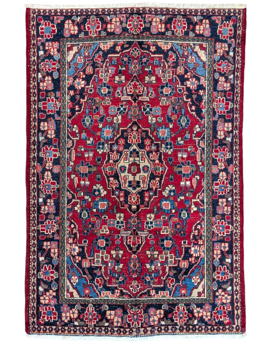 Tappeto Hamedan 190x127 cm annodato a mano, rettangolare, fondo rosso con motivi floreali e geometrici, realizzato in cotone e lana con colori vegetali.