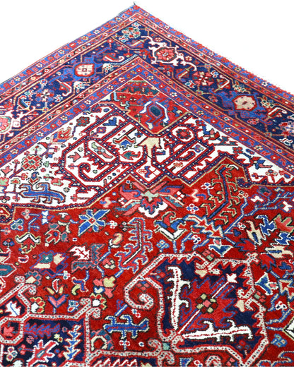 Tappeto Heriz persiano 336x248 cm, annodato a mano in lana e cotone, con medaglione geometrico e motivi floreali tradizionali.