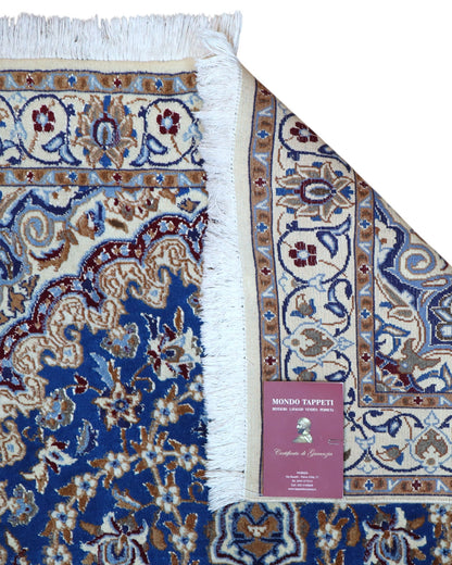 Tappeto Nain 208x120 cm persiano, annodato a mano, fondo blu con medaglione centrale avorio e motivi floreali in lana e seta.