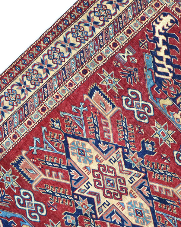 Tappeto Shirvan Afghan 163x127 cm annodato a mano, rettangolare, fondo rosso con motivi geometrici, realizzato in cotone e lana con colori vegetali.