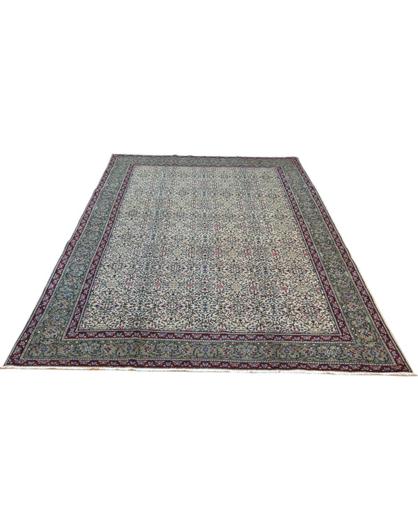 Tappeto Ushak turco 296x198 cm con fondo chiaro e motivi floreali e geometrici in rosa, blu e verde, tramato ed annodato a mano, provenienza Turchia.