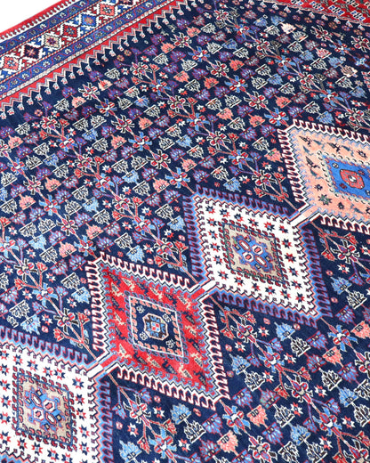 Tappeto Yalame persiano 346x265 cm, annodato a mano in lana e cotone, fondo blu con disegni geometrici tradizionali.