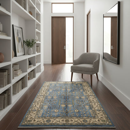 Tappeto Ziegler 188x123 cm con disegno floreale su fondo azzurro e bordura beige, perfetto per arredamenti eleganti e moderni.