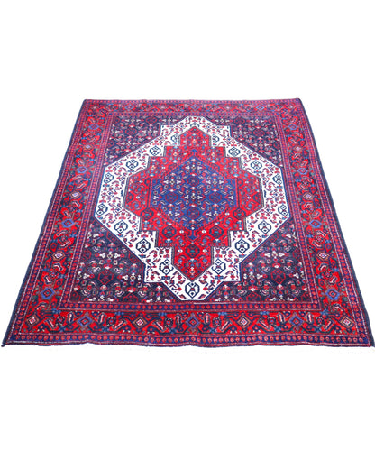 Tappeto Senneh 174x122 cm, annodato a mano, con grande medaglione geometrico centrale e motivi floreali su campo rosso e blu.