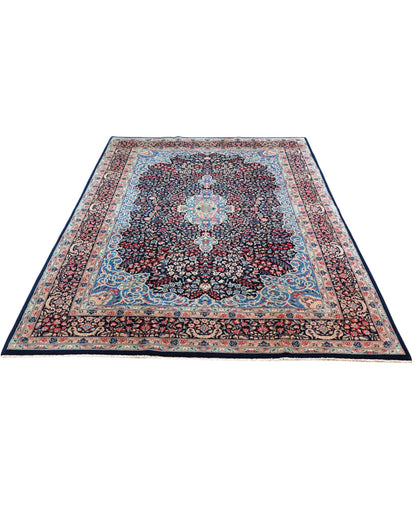 "Tappeto Kerman annodato a mano con motivi floreali in rosso, blu e avorio su fondo blu, 280x189 cm."