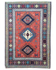 Tappeto tribale rosso 167x117 cm con disegni caucasici in salotto