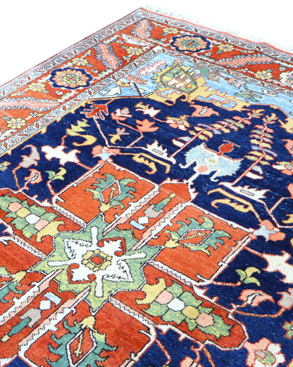 "Tappeto Heriz persiano blu e terracotta con medaglione geometrico, 290x205 cm."