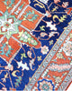 "Tappeto Heriz persiano blu e terracotta con medaglione geometrico, 290x205 cm."