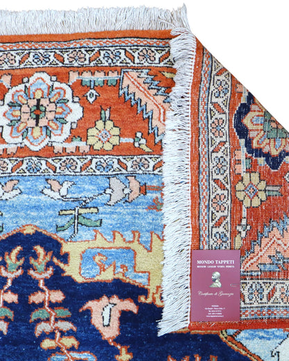 "Tappeto Heriz persiano blu e terracotta con medaglione geometrico, 290x205 cm."