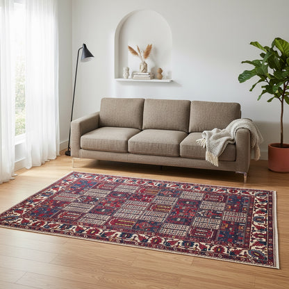 Tappeto persiano Bakhtiar 306x211 cm, motivo a pannelli con decorazioni floreali e geometriche in rosso, blu e avorio, annodato a mano in lana vegetale.