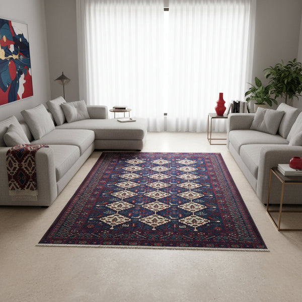 Tappeto afgano 289x196 cm, tramato ed annodato a mano, fondo blu con motivi geometrici in avorio e rosso. Eleganza e tradizione artigianale.
