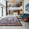 Tappeto persiano Kashmar 384x293 cm, fondo blu con medaglione centrale e motivi floreali e figurativi, annodato a mano in lana vegetale.
