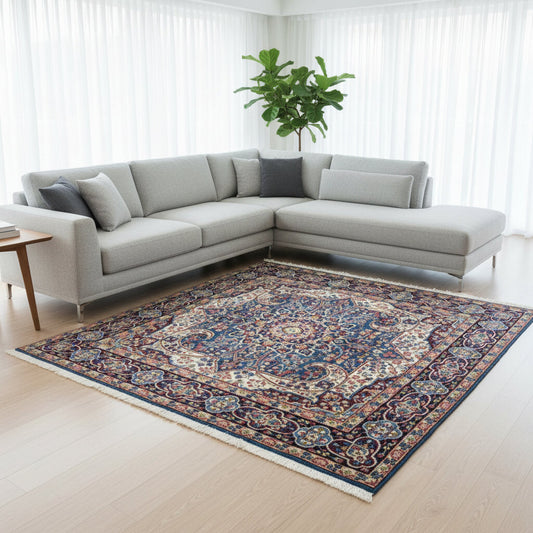 Tappeto Kirman 200x200 cm con motivo floreale centrale in blu, rosso e oro, bordura decorata, annodato a mano con lana pregiata e ordito in cotone.