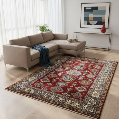 Tappeto Shirvan 300x208 cm con fondo rosso, motivi geometrici blu, gialli e avorio, tramato ed annodato a mano, provenienza Caucaso.