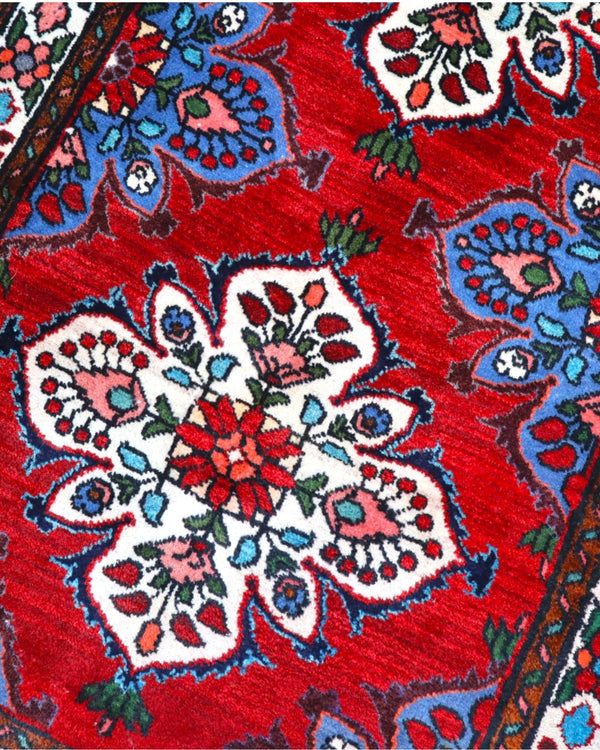 Tappeto Hamedan persiano 167x100 cm annodato a mano, fondo rosso con motivi floreali avorio e dettagli blu, design tradizionale con medaglioni simmetrici