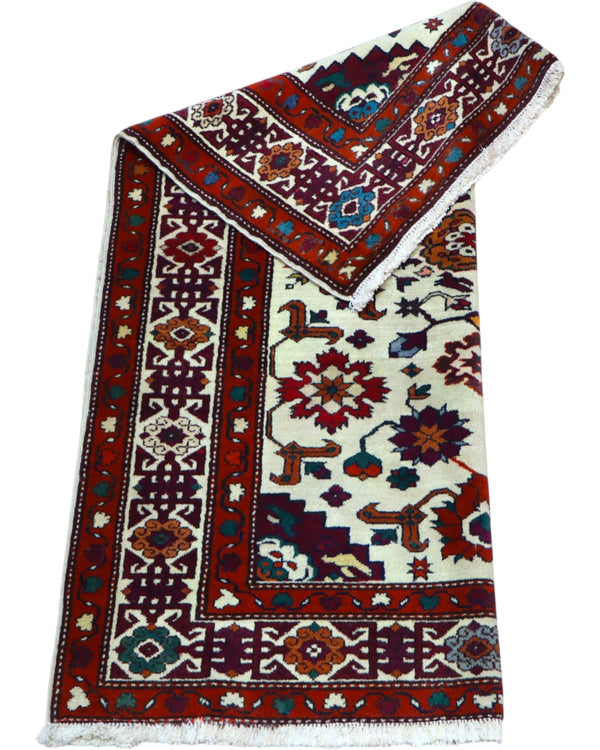 Tappeto Kazak caucasico 130x109 cm annodato a mano, fondo avorio con motivi geometrici e floreali colorati