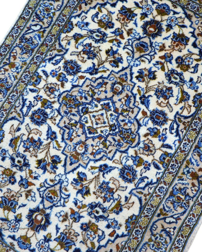 Tappeto Nain persiano 148x100 cm annodato a mano, fondo avorio con medaglione centrale e motivi floreali blu eleganti